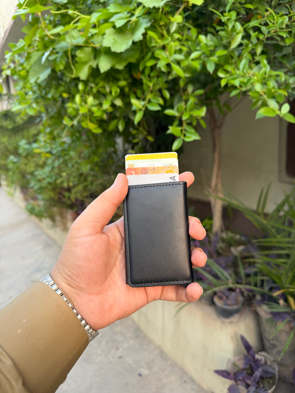 Black Pop-Up Bifold Wallet with cards ejected showing UBL and Allied Bank cards