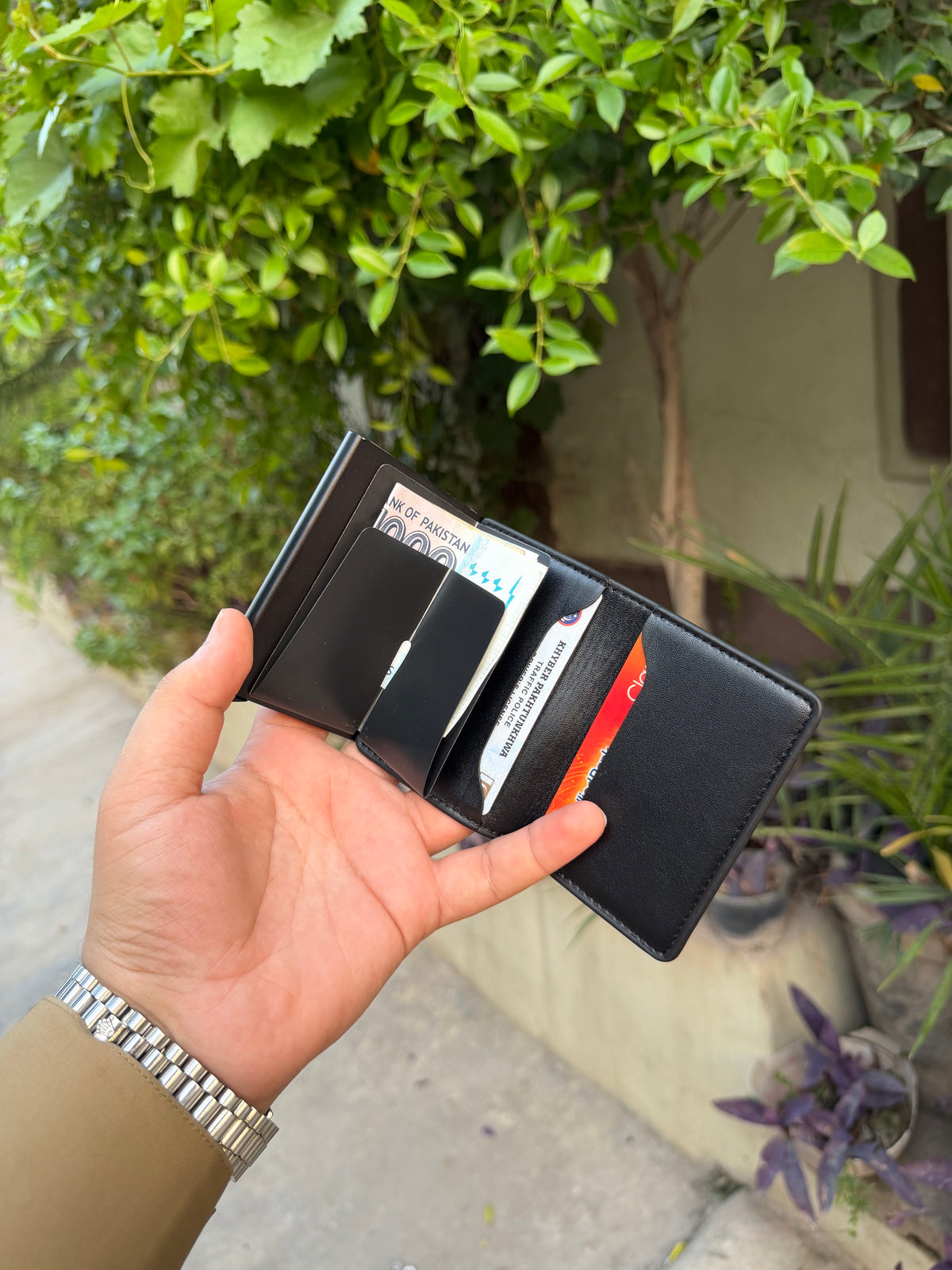 Black Pop-Up Bifold Wallet fully open showing bifold cash section with Pakistani currency and multiple card slots