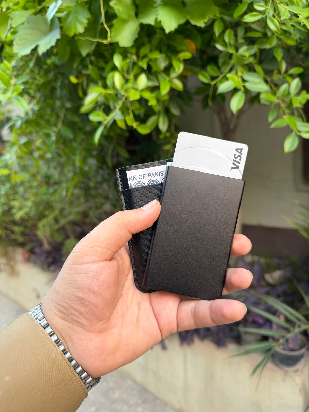 Black Carbon Fibre Wallet fully loaded with multiple cards fanned out and cash slot