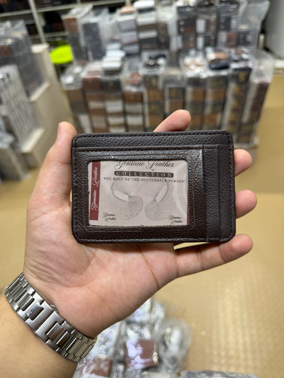 Dark Brown Slim Card Holder front view showing ID window and Genuine Leather Collection branding