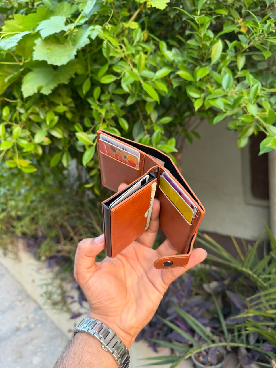 Tan Leather Pop-Up Card Holder Wallet with cards fanned out from pop-up mechanism