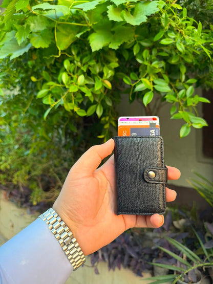 Black Pop-Up Card Wallet with cards ejected showing Visa and debit cards