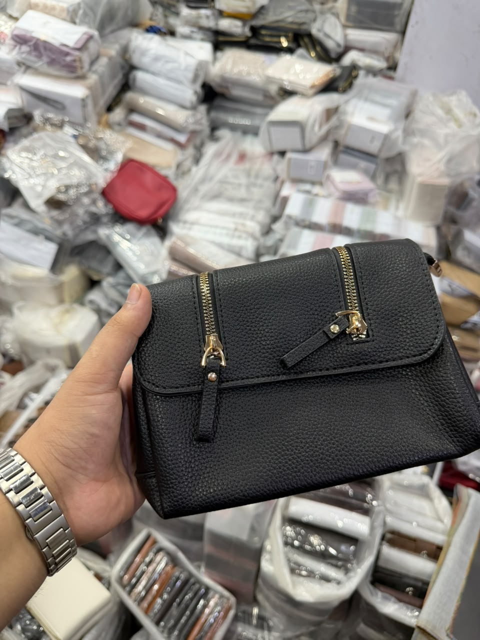 Black Dual-Zip Crossbody Bag front view showing two gold zippers and snap flap